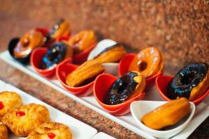 a tray of donuts in little red bowls at Elegant Hotel & Resort in Tsaghkadzor +98 photos