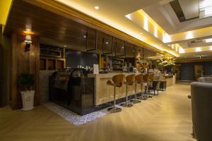 a restaurant with a bar with stools at G11 Hotel in Taichung