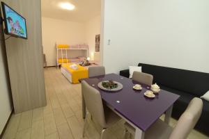 a dining room with a purple table and chairs at Case Vacanza Via Mozart in Porto Cesareo