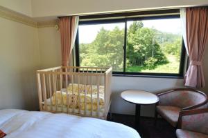 Postel nebo postele na pokoji v ubytování Hakuba Yamano Hotel