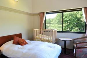 Postel nebo postele na pokoji v ubytování Hakuba Yamano Hotel