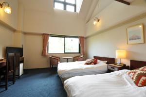 Postel nebo postele na pokoji v ubytování Hakuba Yamano Hotel