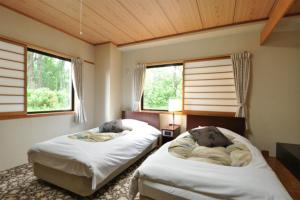 Postel nebo postele na pokoji v ubytování Hakuba Yamano Hotel