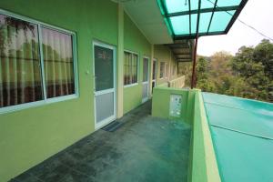 a balcony of a building with a swimming pool at Narra Homestay in Maskeliya