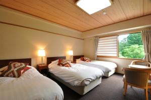 Postel nebo postele na pokoji v ubytování Hakuba Yamano Hotel