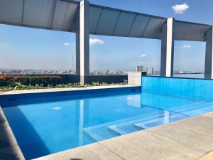 a swimming pool on the roof of a building at Vinia Residences + Versaflats in Manila