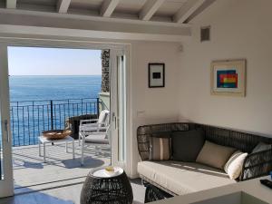 a living room with a couch and a view of the ocean at Fivestay Casa Gabriella in Vernazza