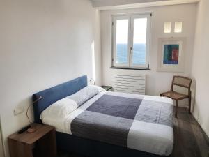 a bedroom with a bed and a window and a chair at Fivestay Casa Gabriella in Vernazza +32 photos