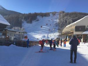 un grupo de personas en una pista de esquí con remonte en Serre Chevalier -Cosy Apartment "Le Coolidge" for 7 down the slopes with stunning view en Saint-Chaffrey