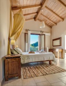a bedroom with a large bed and a large window at Mastrogiannis villa Dafne in Kavvadádes