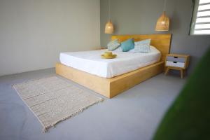 a bedroom with a bed with a hat on it at Cap Heureux Villas in Cap Malheureux