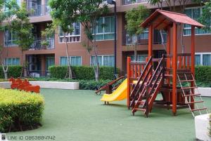 a playground in front of a building with a slide at Baan Thew Lom Condo Cha am By PoPu in Ban Sahakham