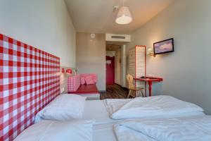 Posteľ alebo postele v izbe v ubytovaní MEININGER Hotel Salzburg City Center
