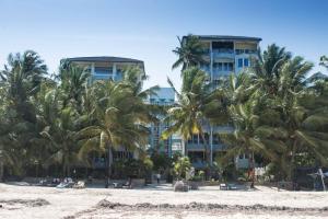 a hotel on the beach with palm trees at Modern Beach Front Studio Apartment - B44 in Mombasa
