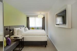 Vuode tai vuoteita majoituspaikassa H+ Hotel Wien
