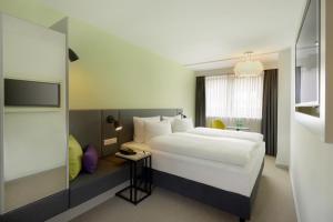 Vuode tai vuoteita majoituspaikassa H+ Hotel Wien