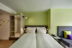 Vuode tai vuoteita majoituspaikassa H+ Hotel Wien
