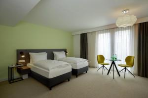 Vuode tai vuoteita majoituspaikassa H+ Hotel Wien