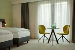 Vuode tai vuoteita majoituspaikassa H+ Hotel Wien