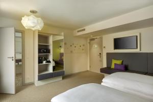 Vuode tai vuoteita majoituspaikassa H+ Hotel Wien