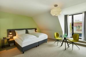 Vuode tai vuoteita majoituspaikassa H+ Hotel Wien