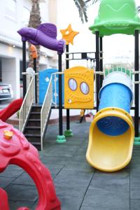 a childrens playground with a slide and a play structure at Western Gate Residence 1 - Amman, Jordan in Amman