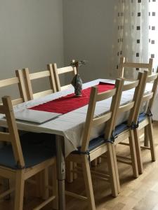 a dining room table with a red and white table cloth at City Center Studio in Graz