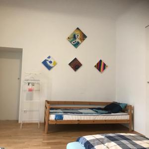 a bedroom with a bed and kites on the wall at City Center Studio in Graz