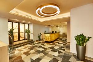 an office lobby with a checkered floor at H+ Hotel Wien in Vienna