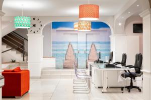 an office with a mural of a beach at Aparthotel Los Dragos del Sur in Puerto de Santiago