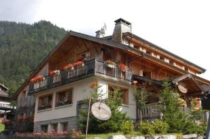 a large wooden house with flowers on the balcony at Chalet Philibert in Morzine