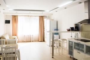 a kitchen and living room with white appliances at ABC Apartments Business Class in Kyiv