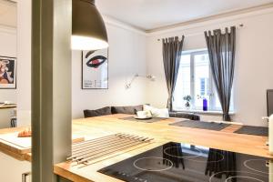 a kitchen and living room with a wooden table at Smulikowskiego 2 in Warsaw