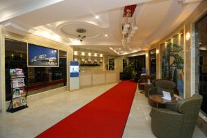 a lobby with a red carpet and a waiting room at Parliament Palace Hotel in Khujand +37 photos