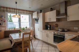 a kitchen with a table and a dining room at Haus Herdlitschke - auch für Monteure in Polle