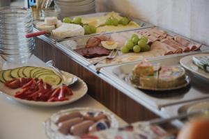 a buffet filled with different types of food on plates at Villa zur schönen Aussicht in Bad Salzuflen