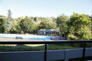 a swimming pool with a building in the background at New Bath Hotel & Spa in Matlock