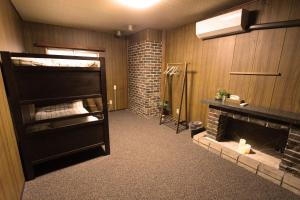 a room with a bunk bed and a fireplace at Hibari House in Okayama