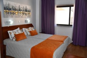Postel nebo postele na pokoji v ubytování Hotel Anjos