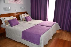 Postel nebo postele na pokoji v ubytování Hotel Anjos