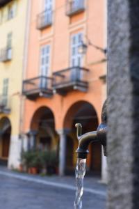 a water fountain in front of a building at Albergo e Ostello della gioventù Biella centro storico in Biella