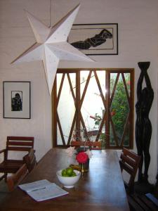 a dining room with a wooden table with a large star ceiling at Alternative Space Bed and Breakfast in Swakopmund