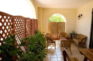 a room with chairs and a table and an arched window at L'antico Trullo - Masseria Chiancarella in Fasano