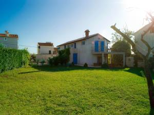 a house in a yard with a grass yard at House Ivas with garden in Zambratija