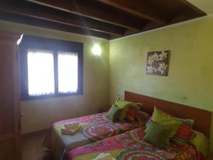 A bed or beds in a room at Casa de aldea Collera