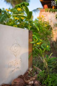 a sign for a villa with plants and flowers at Zuri Zanzibar in Kendwa