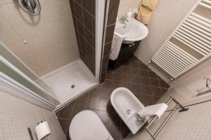 a small bathroom with a sink and a toilet at Appartamento Balkissa in San Felice del Benaco +13 photos