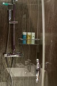 a bathroom with a shower with a rack of toiletries at Garden House in Masham +45 photos