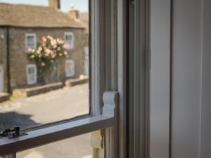 a window with a view of a building at Garden House in Masham