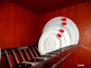 a row of plates hanging on a wall at Lirio Guest House in Makrakómi